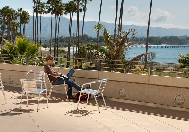 Student studying on MSI terrace with ocean view